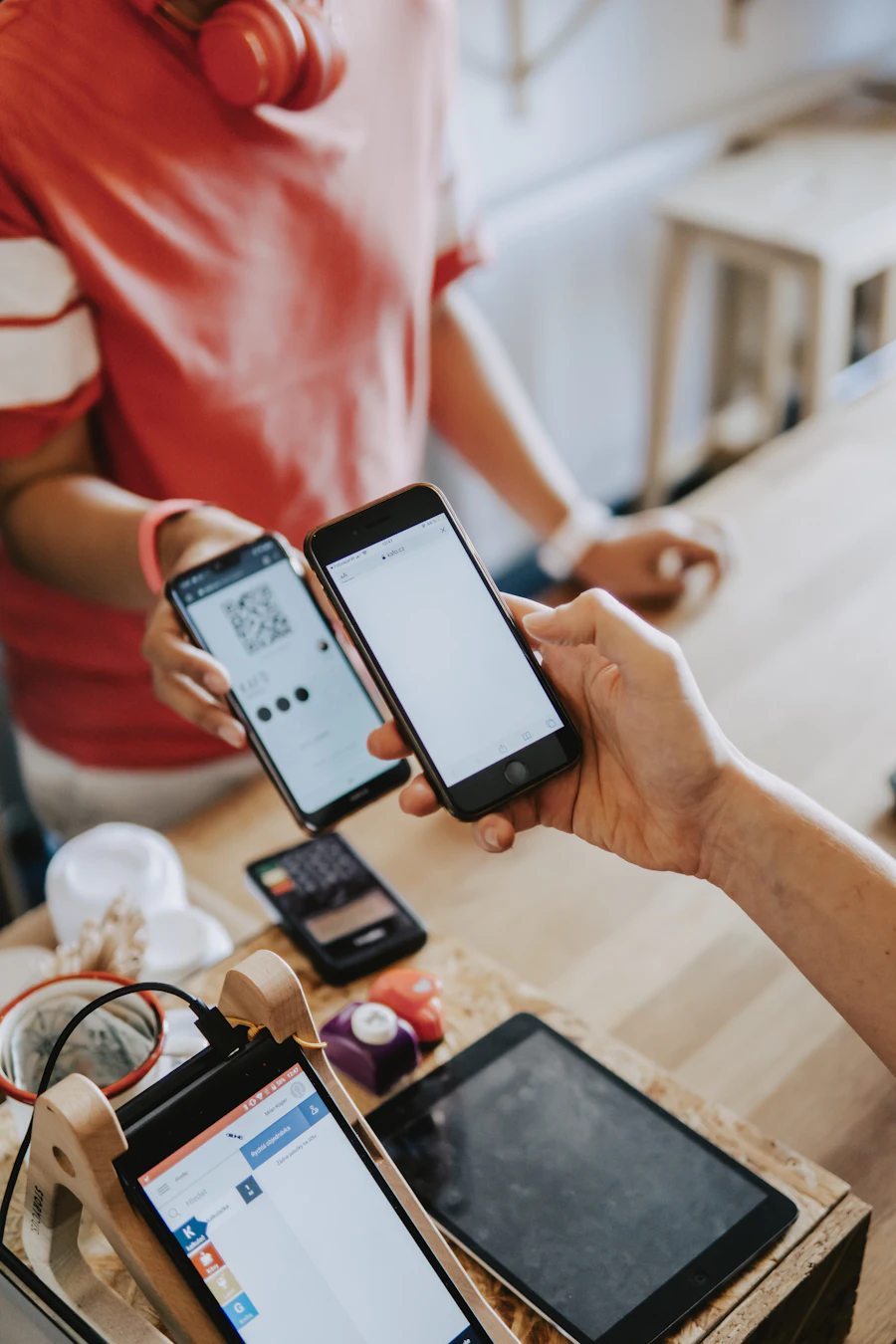 Two people using banking apps on their phones