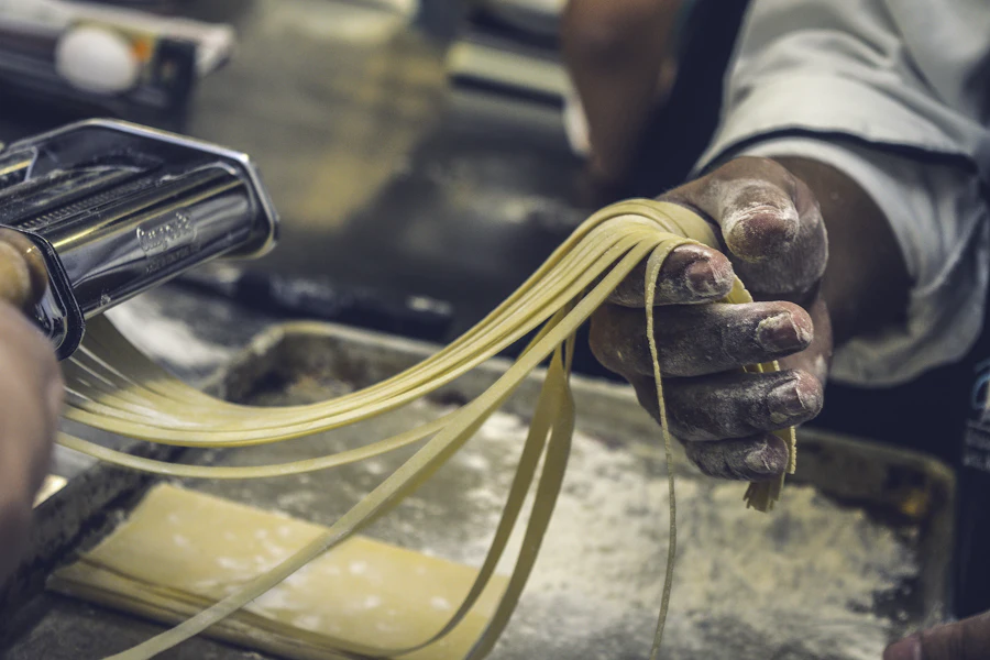 Pasta dough being rolled by hand