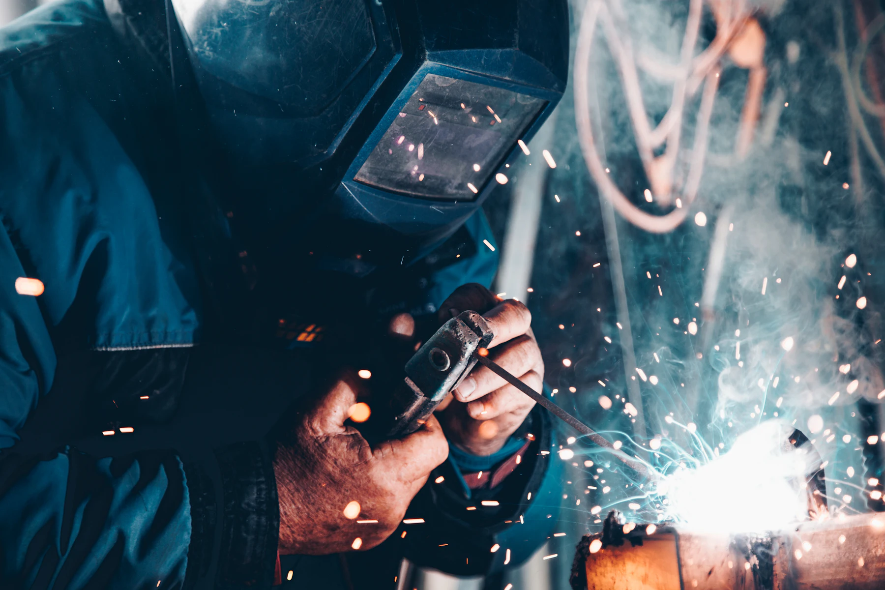 Welder at work with sparks